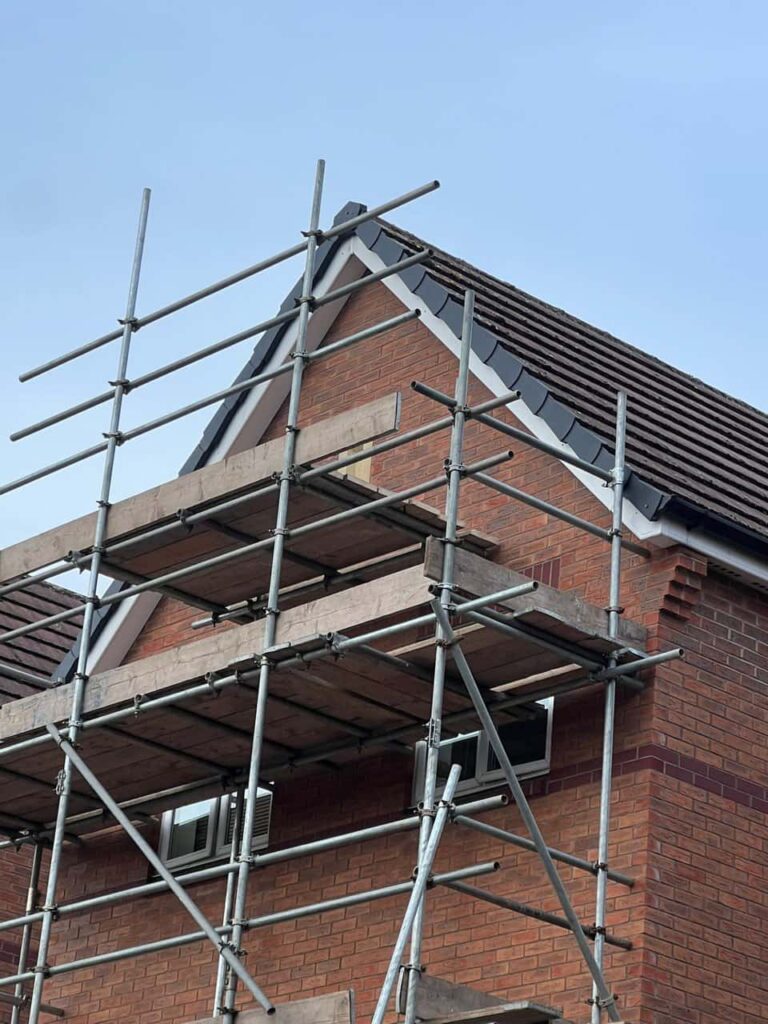 This is a photo of a roof which has just been repaired. There is a scaffold located at the gable end for access onto the roof. Works carried out by LJ Roofing Corsham